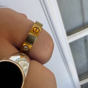 Gold tone ring w/ motif screws